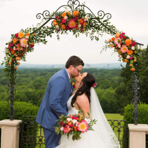 Bridal Flower Bouquet and Wedding Arches in warm oranges and pinks